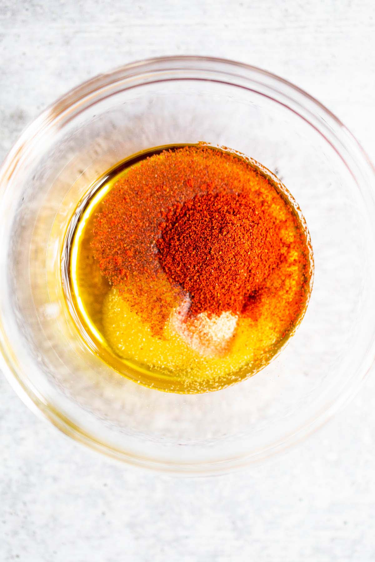 Olive oil, paprika, and salt in a bowl.