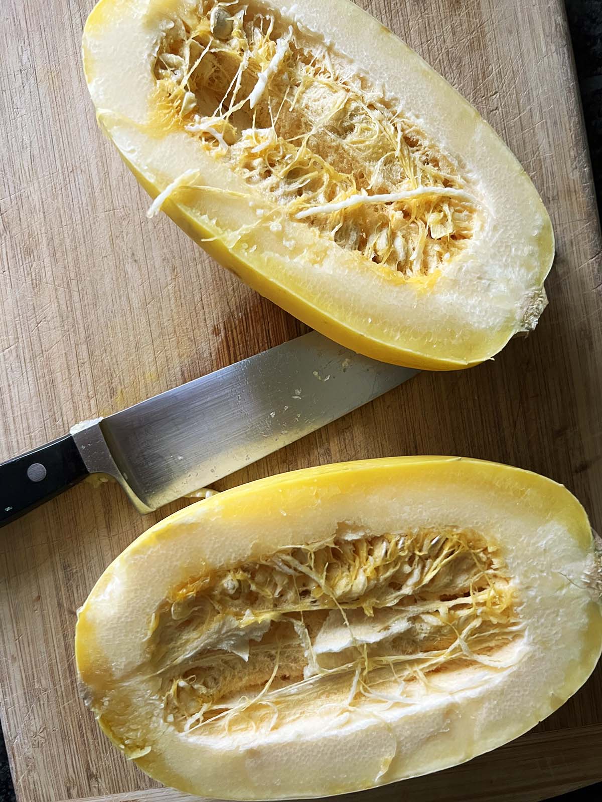 Slicing spaghetti squash in half.