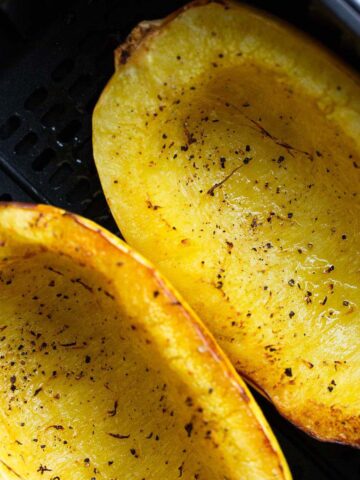 Spaghetti squash in air fryer basket.