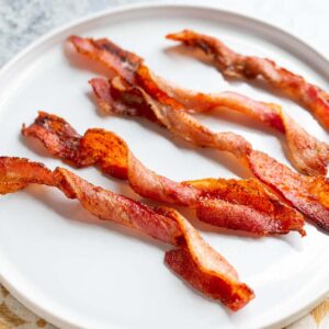 Air fryer twisted bacon on a white plate.