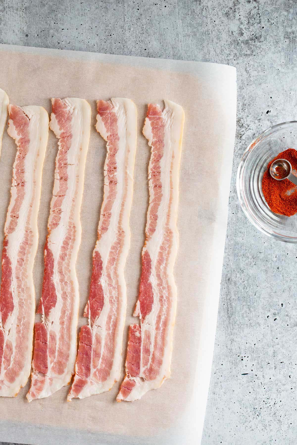 Bacon strips on parchment paper.