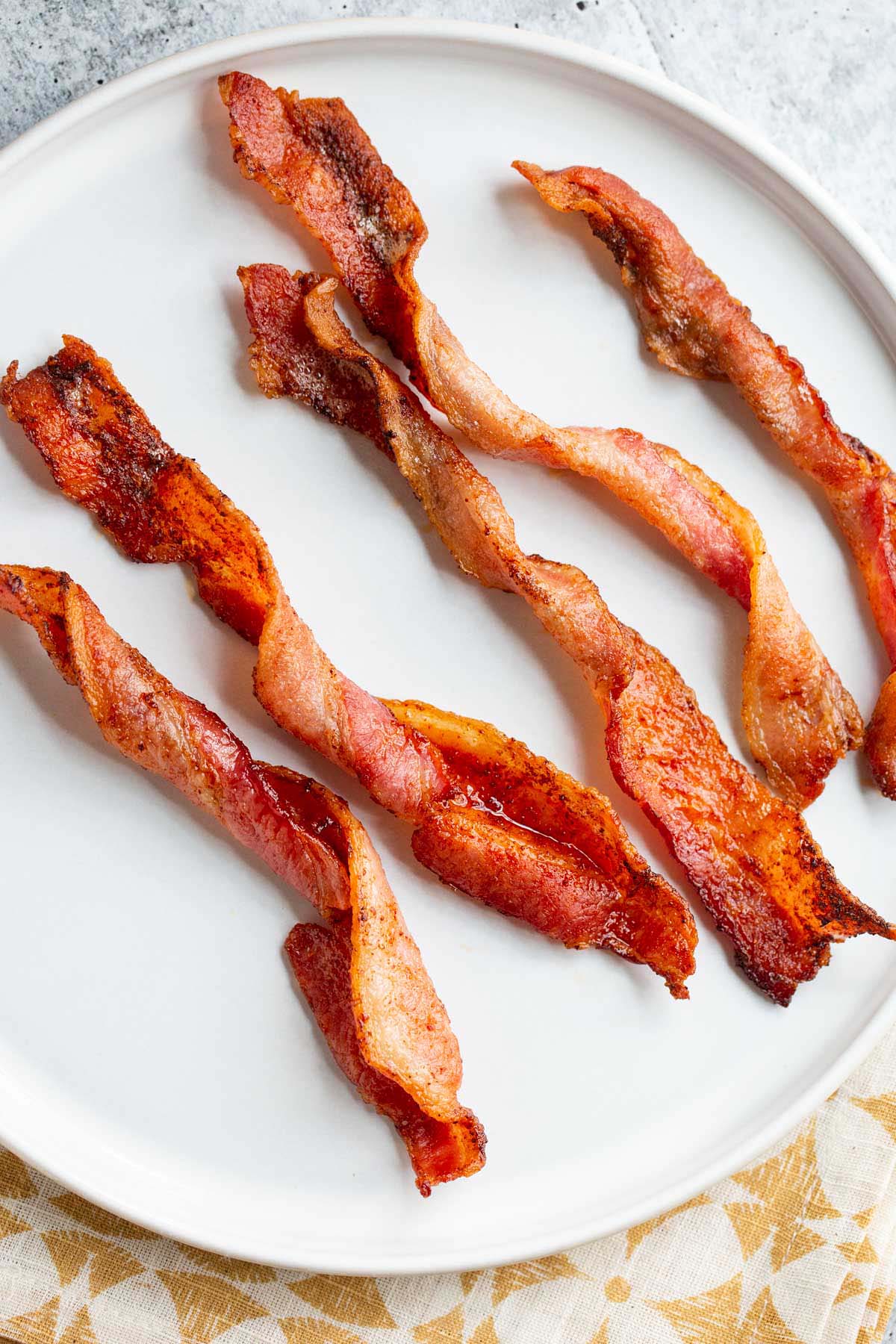 Twisted bacon on a white plate.