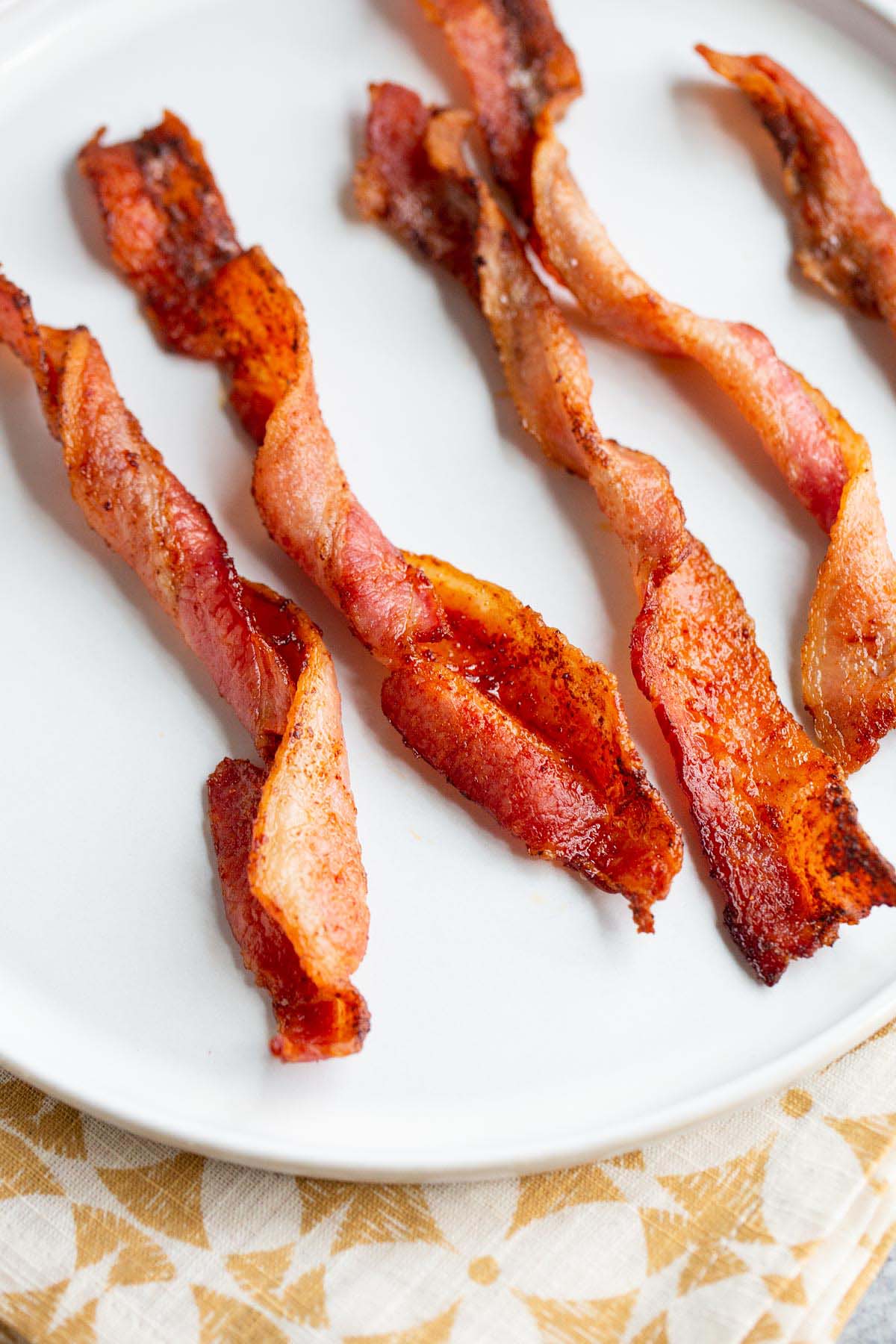 Twisted bacon on a white plate.