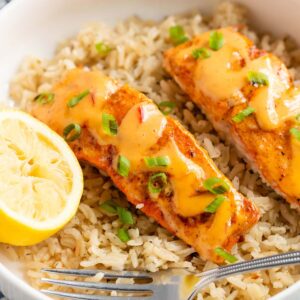 Salmon with bang bang sauce and green onions.