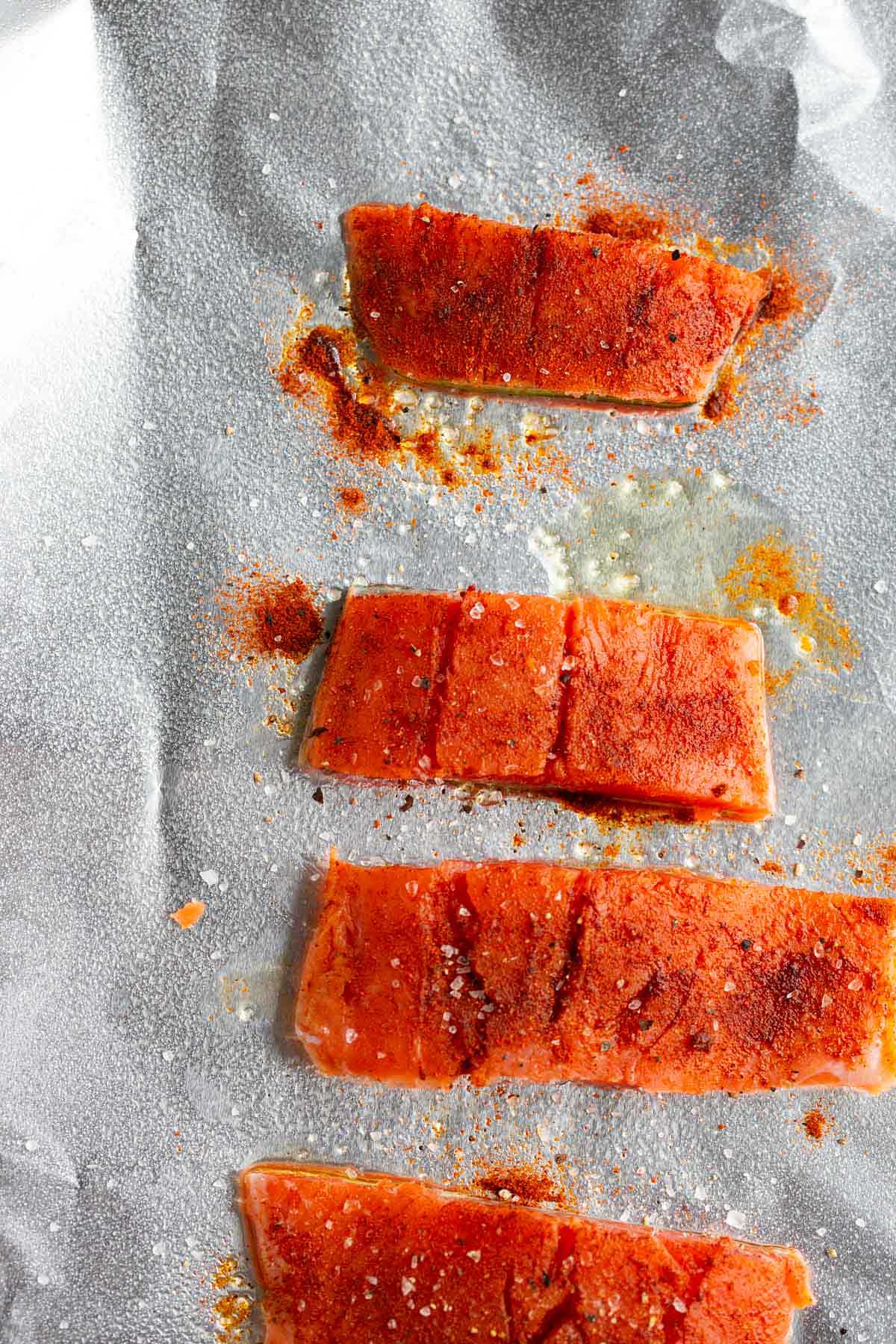 Uncooked salmon on a baking sheet.