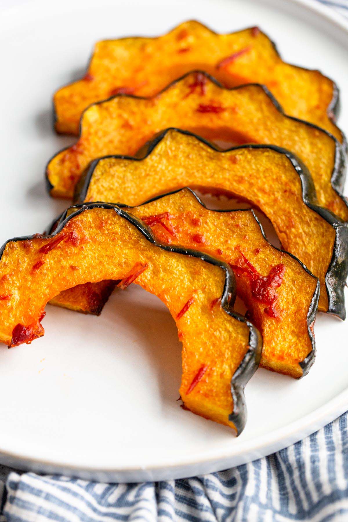 Harissa roasted acorn squash on a plate.