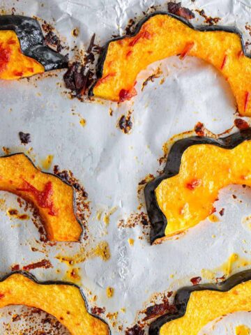 Harissa Acorn Squash on baking sheet.