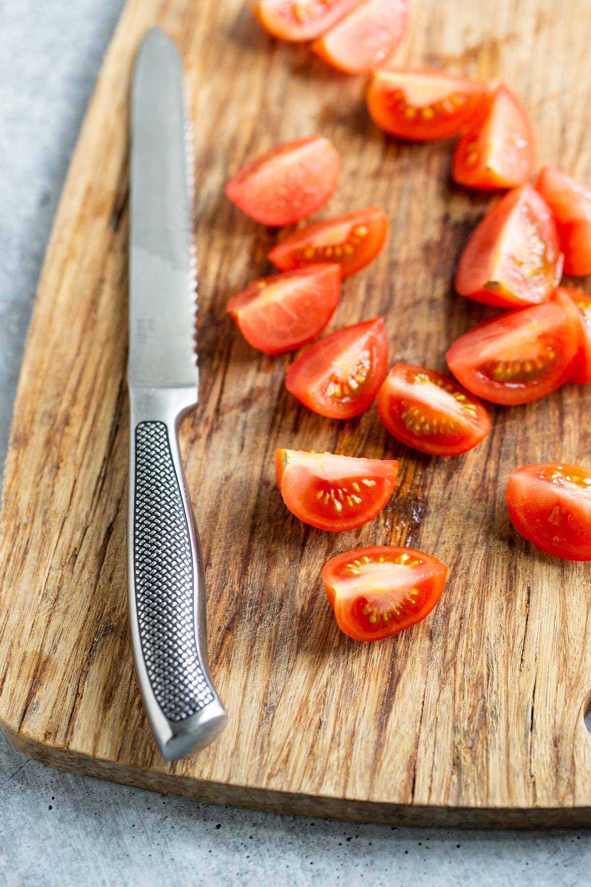 Diced tomatoes on a cutting board.