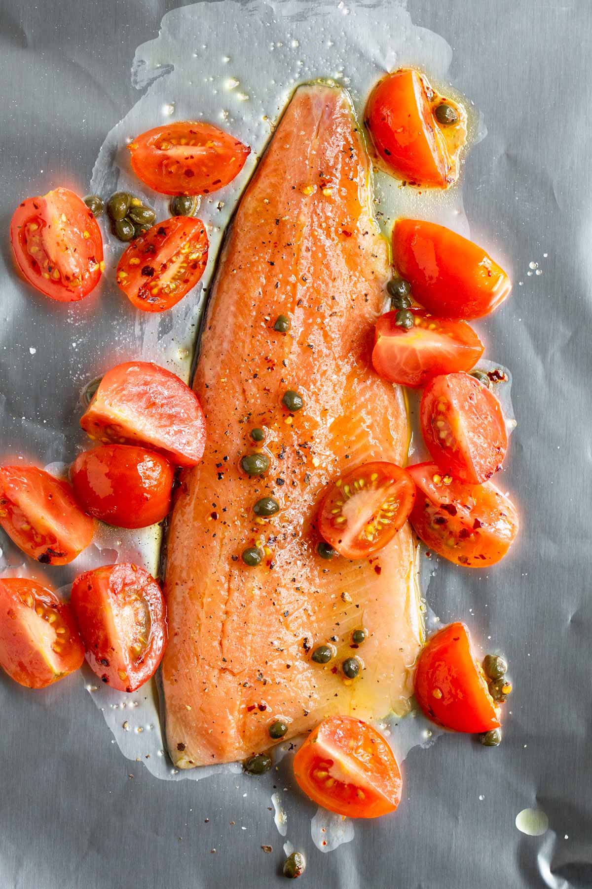 Uncooked rainbow trout on a sheet pan.