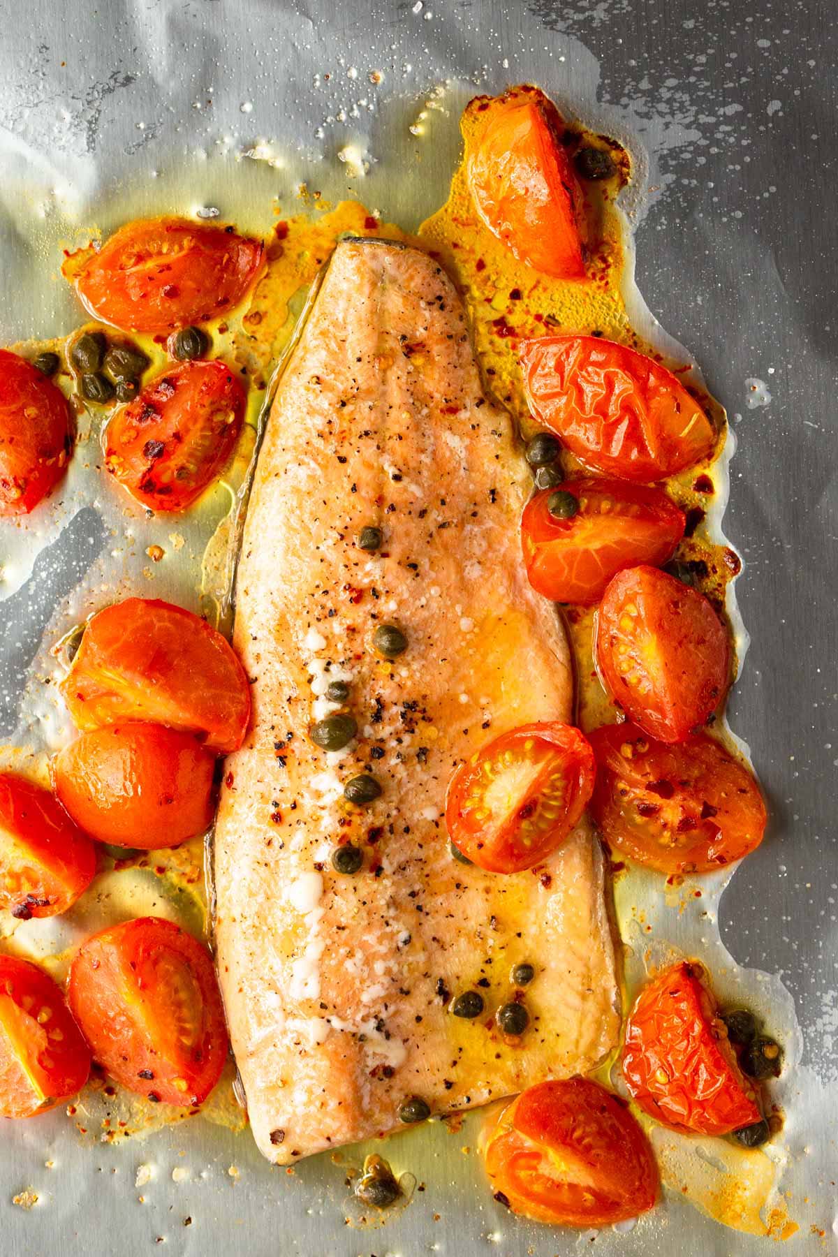 Cooked rainbow trout on a sheet pan.