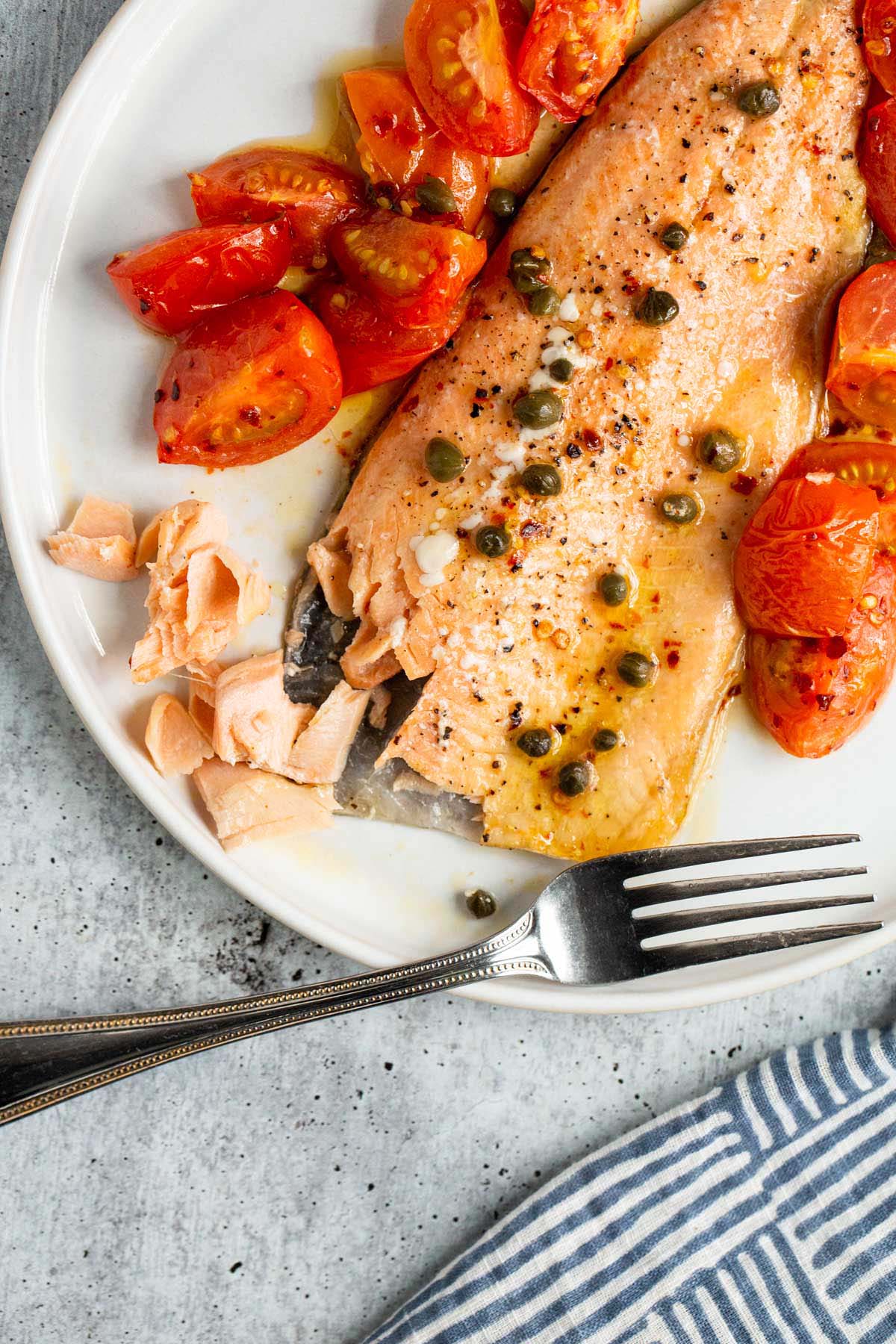 Cooked rainbow trout being flaked.