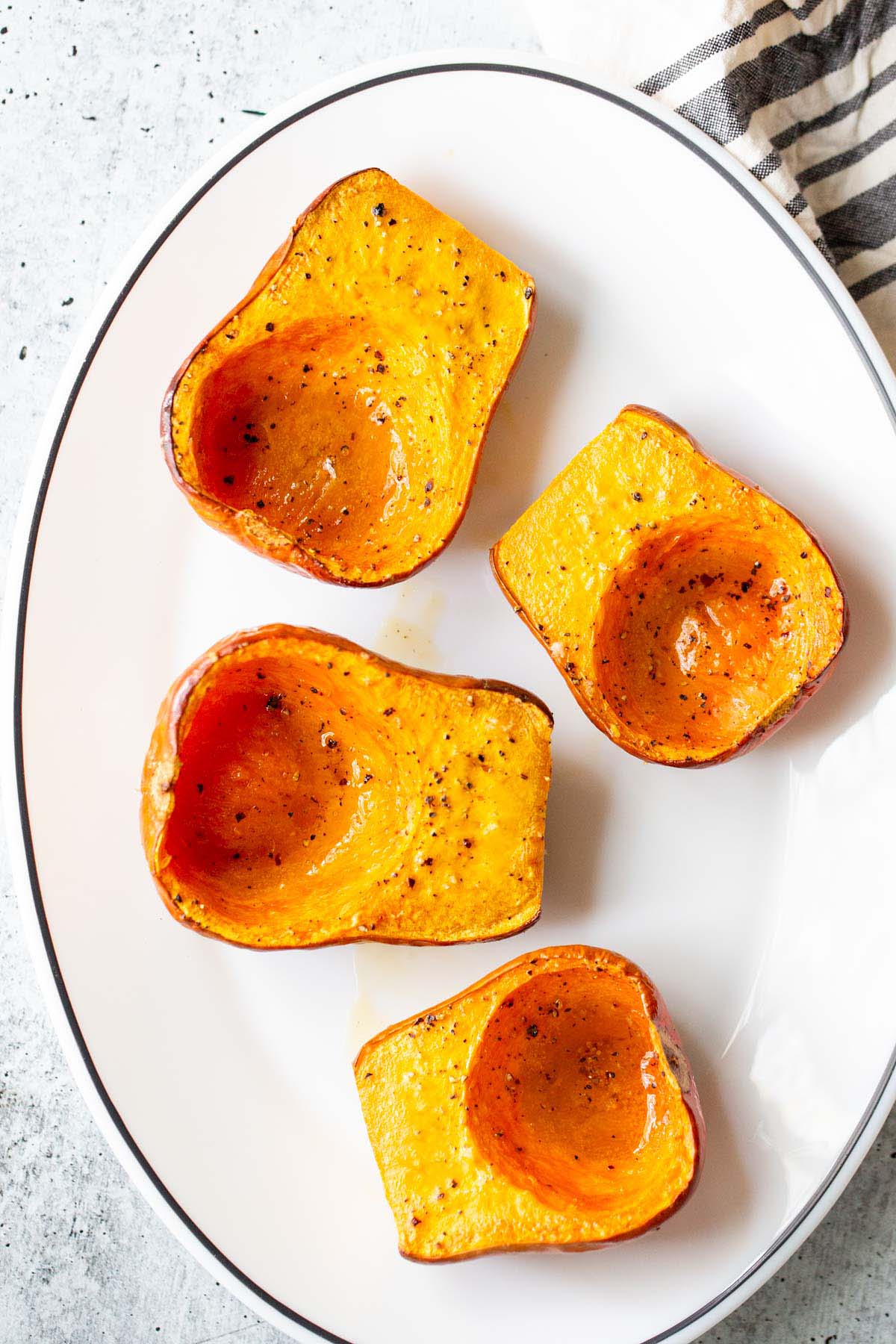 Roasted honeynut squash on a plate.