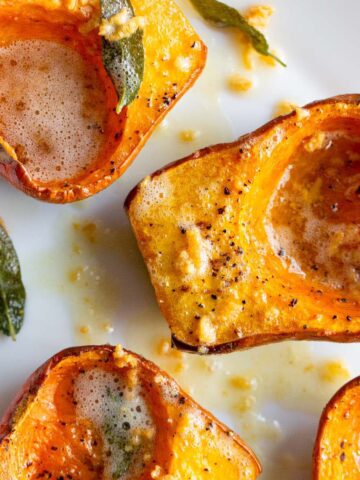 Roasted honeynut squash topped with a sage garlic butter.