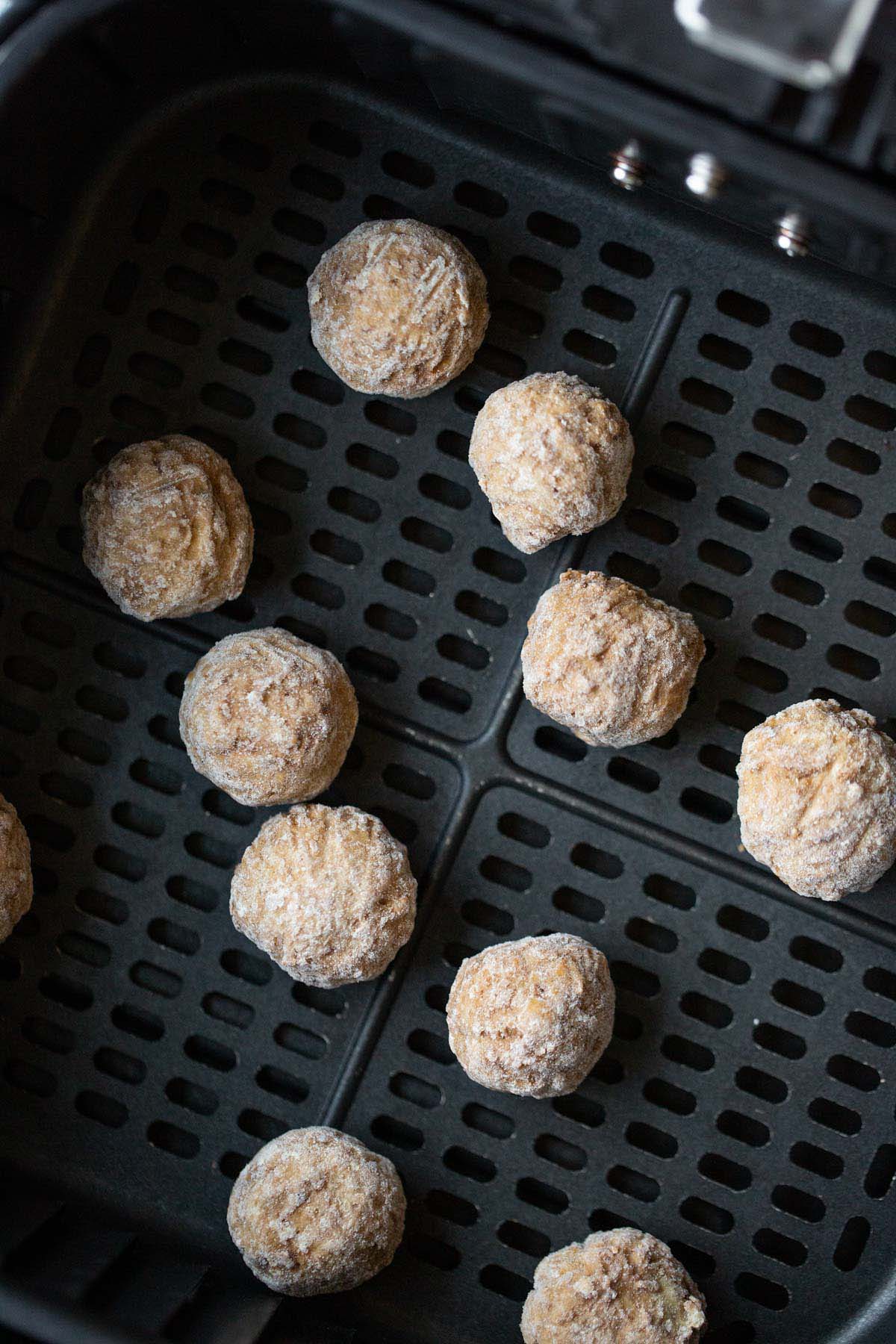 Frozen ikea meatballs in air fryer basket.