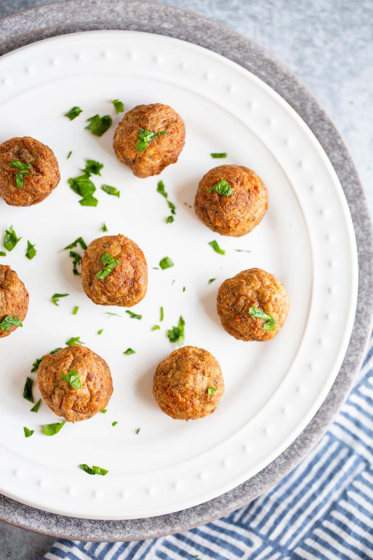 Cooked ikea swedish meatballs on a white plate.