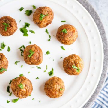 Air fried IKEA meatballs on a white plate.