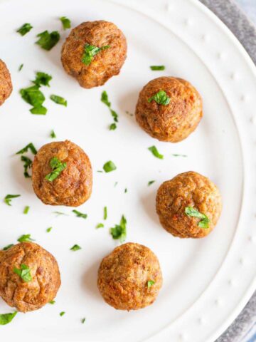 Air fried IKEA meatballs on a white plate.