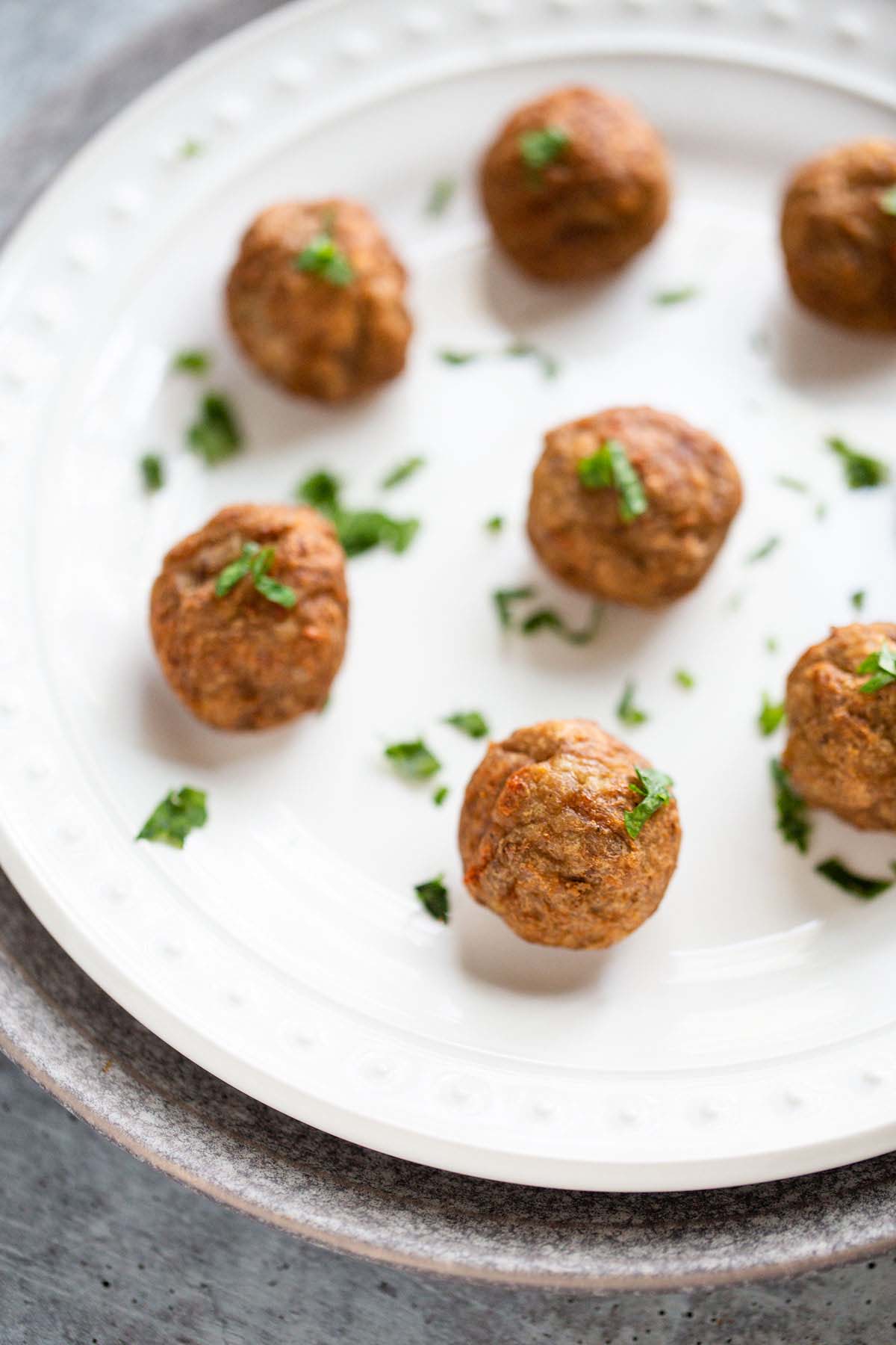 Swedish meatballs on a white plate.