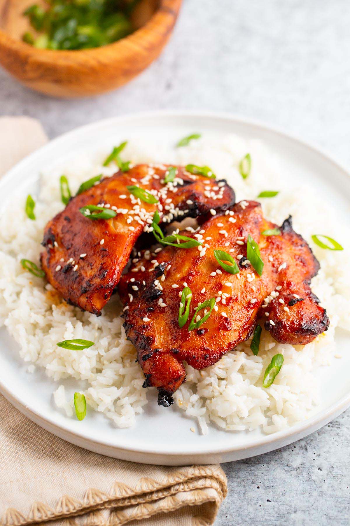 Gochujang chicken thighs on a bed of rice.