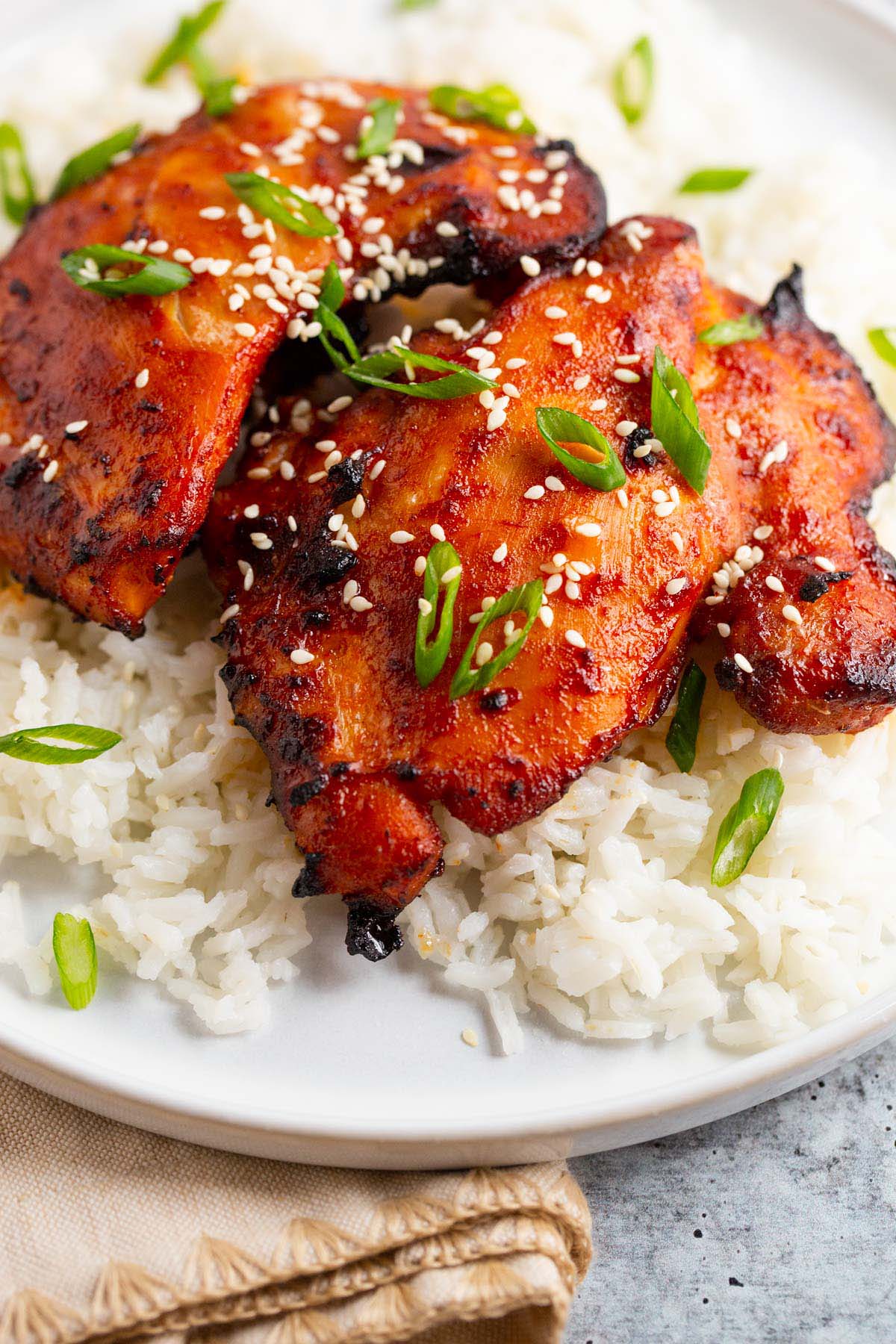 Gochujang chicken thighs on a bed of rice.