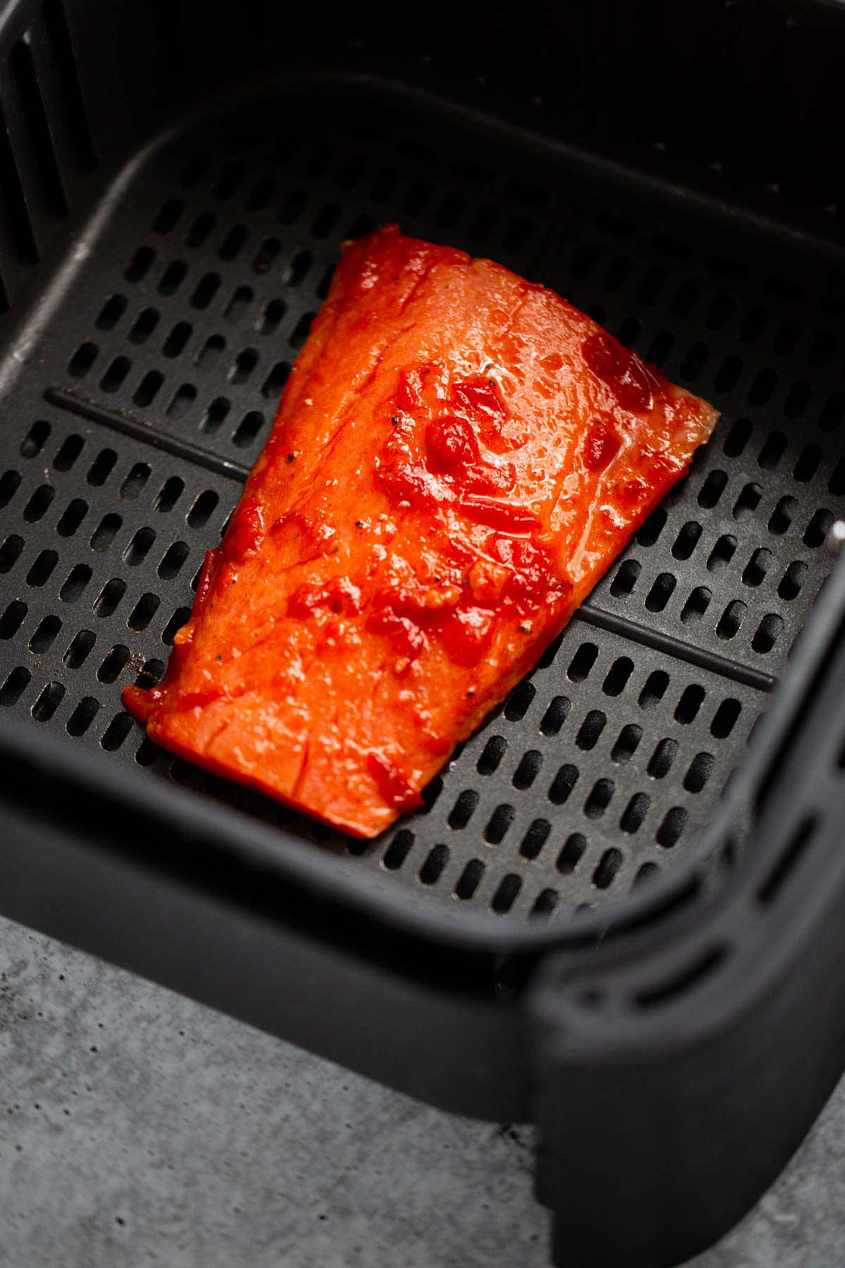 Salmon in the air fryer basket.