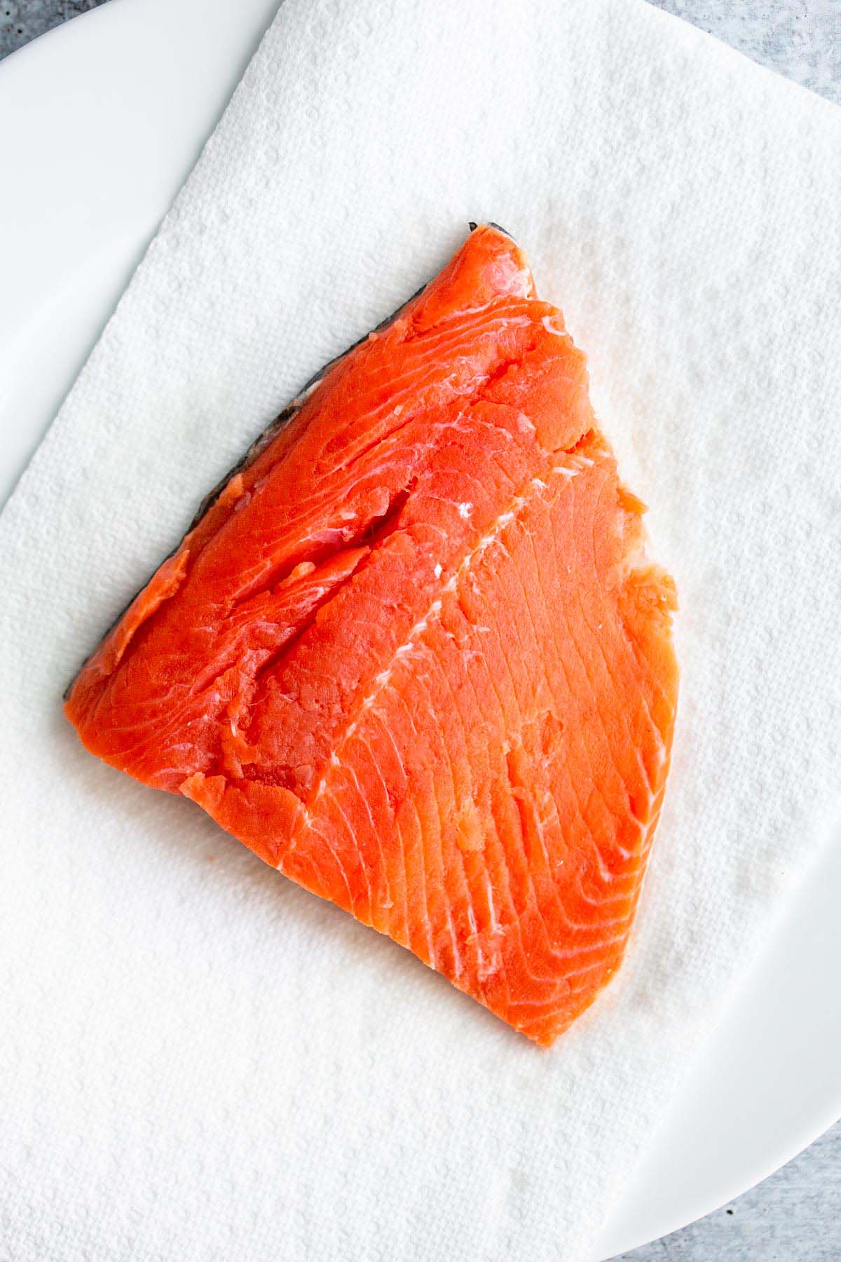 Salmon fillet on paper towels.