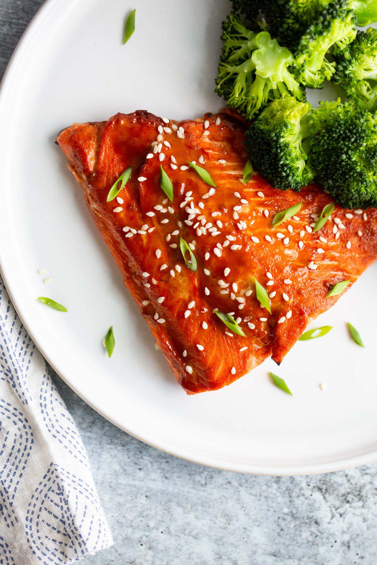 Miso salmon topped with sesame seeds and sliced green onions.