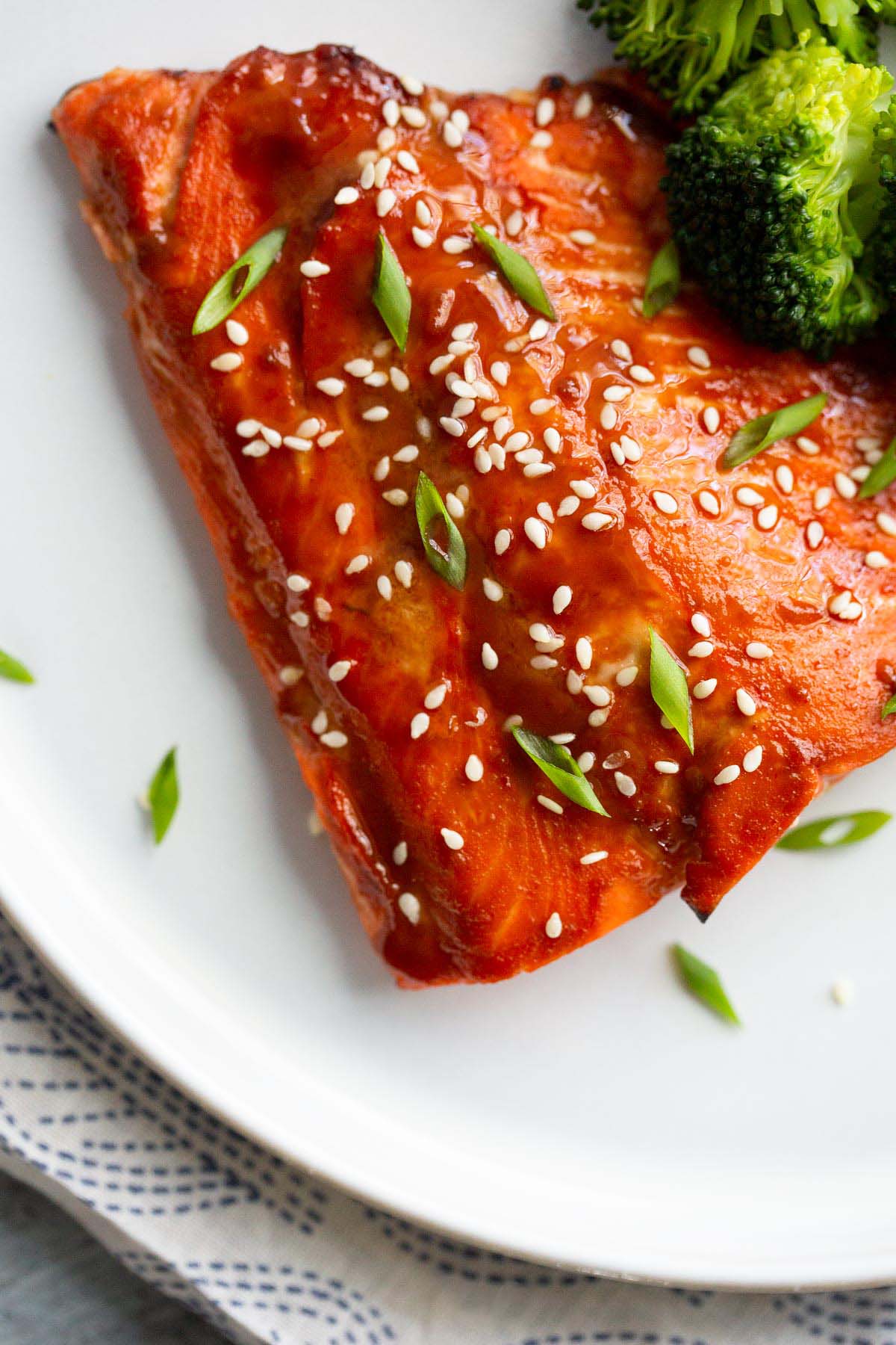 Miso salmon topped with sesame seeds and sliced green onions.