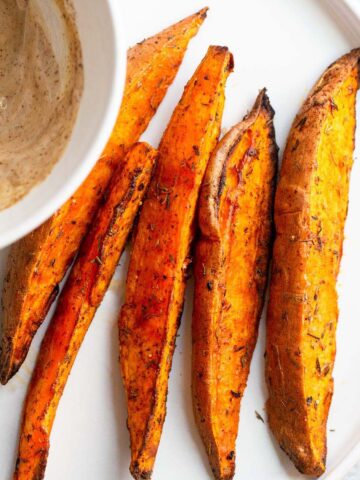 sweet potato wedges on a white plate.