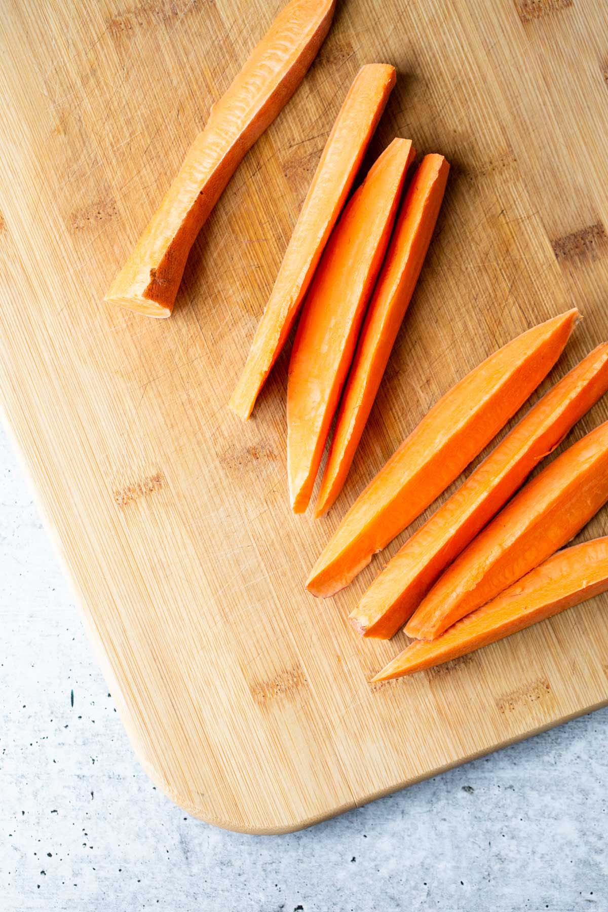 Sliced sweet potato on a cutting board.