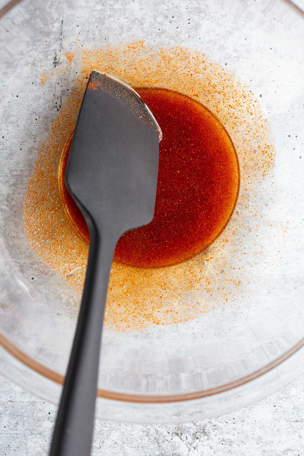 Oil and spices mixed together in a bowl.