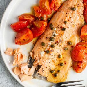 Baked rainbow trout with capers and tomatoes.