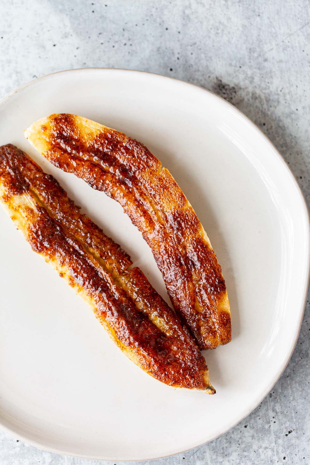 Caramelized banana on a white plate.