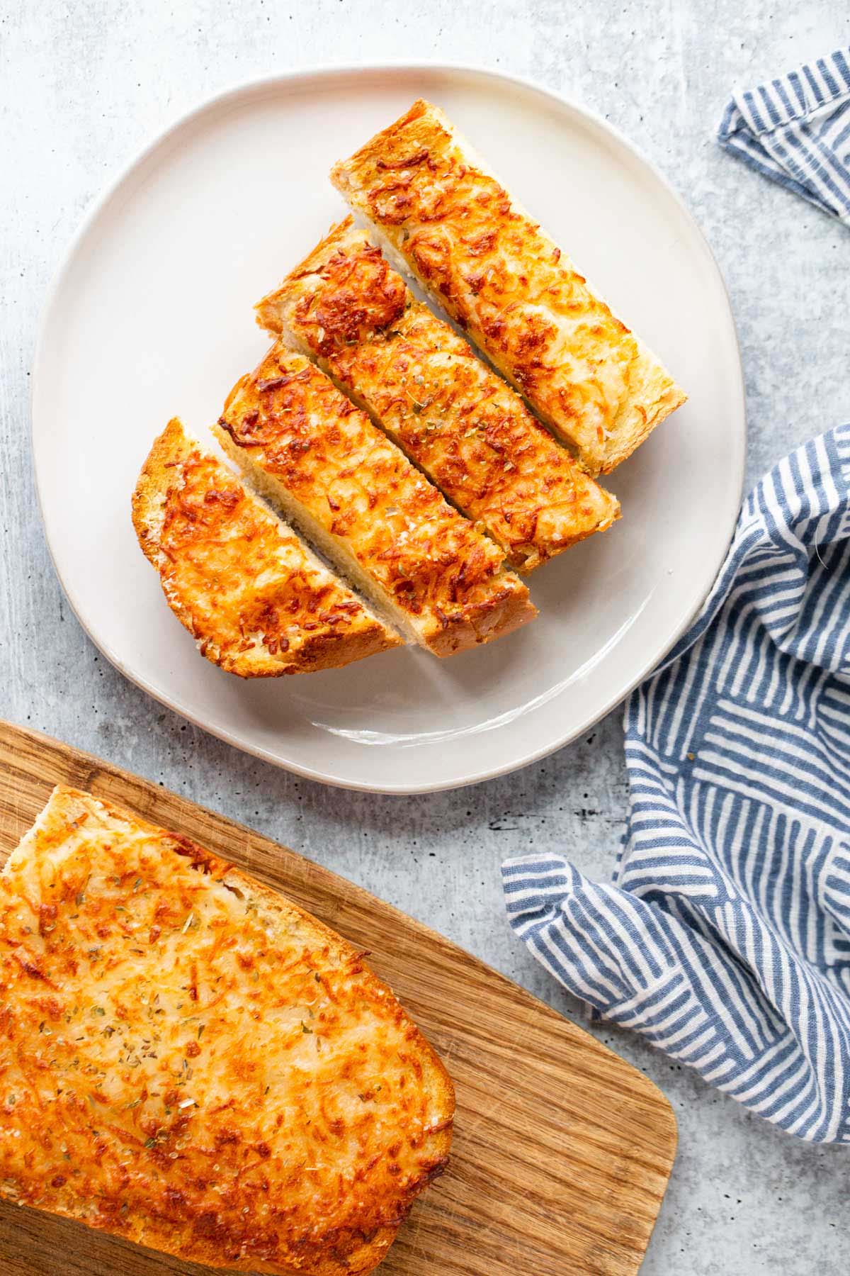 Sliced garlic bread on a plate from above.