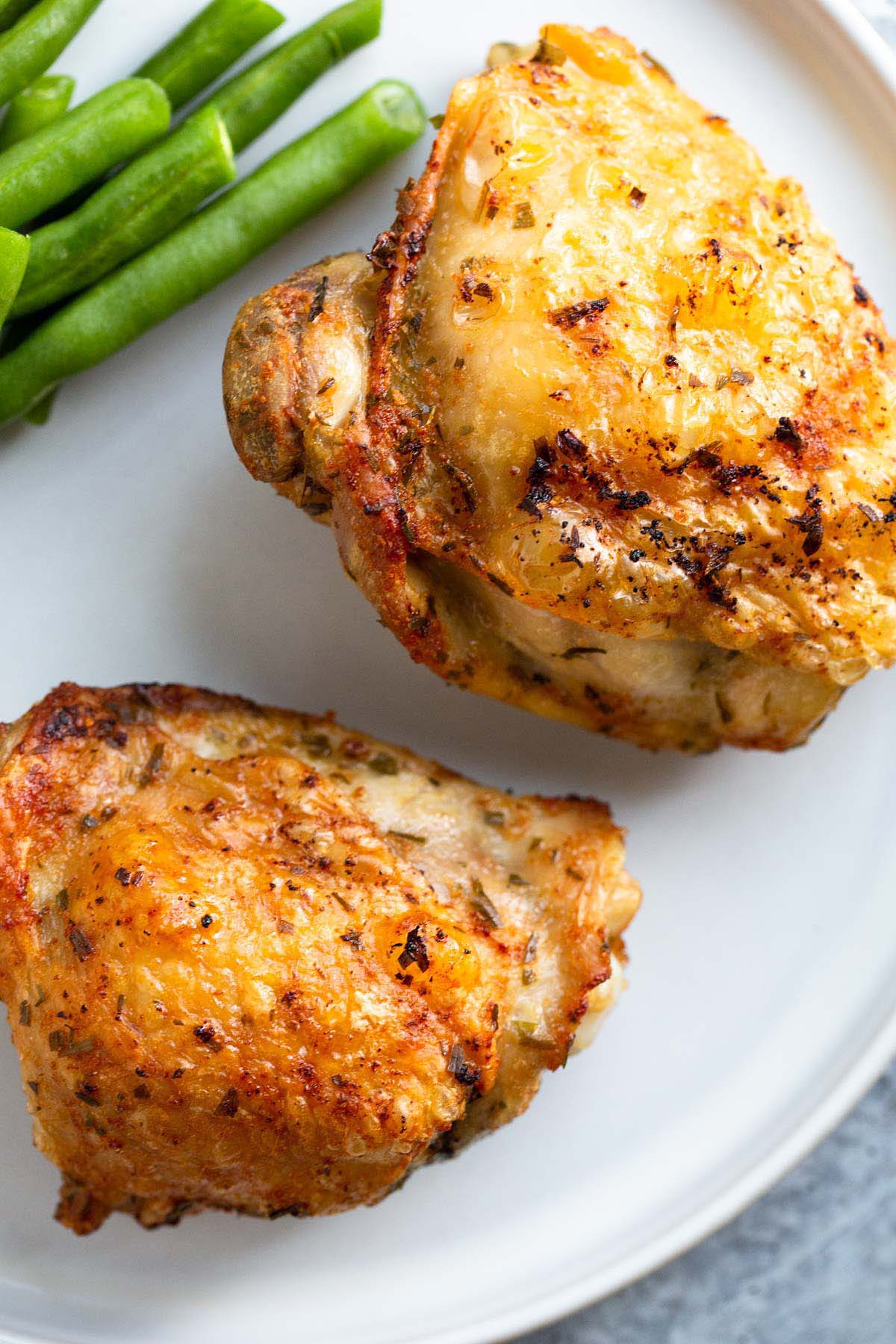 Crispy chicken thighs on a plate.