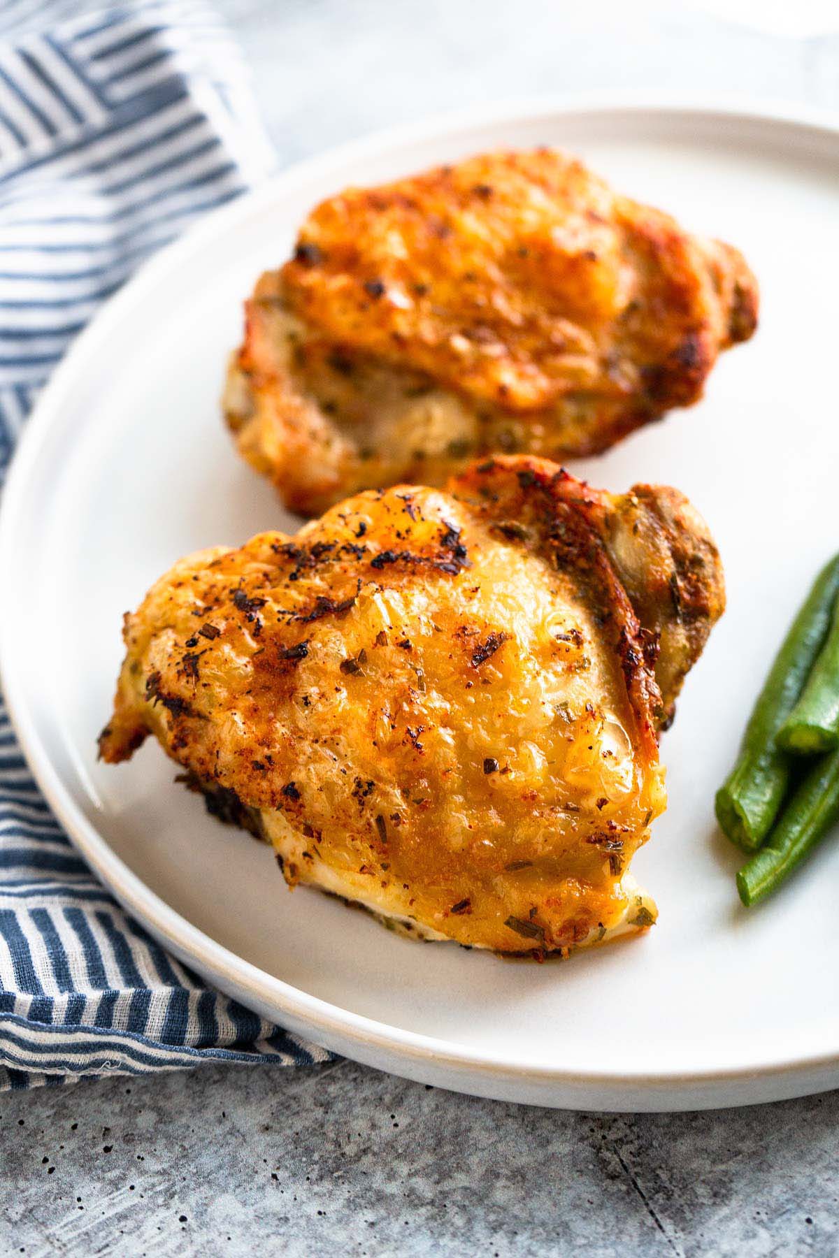 Crispy chicken thighs on a plate.