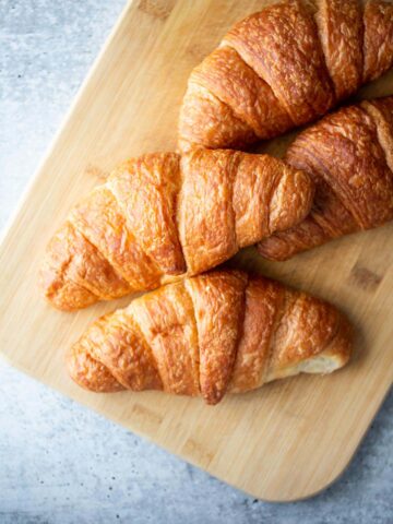 Croissants on a cutting board.