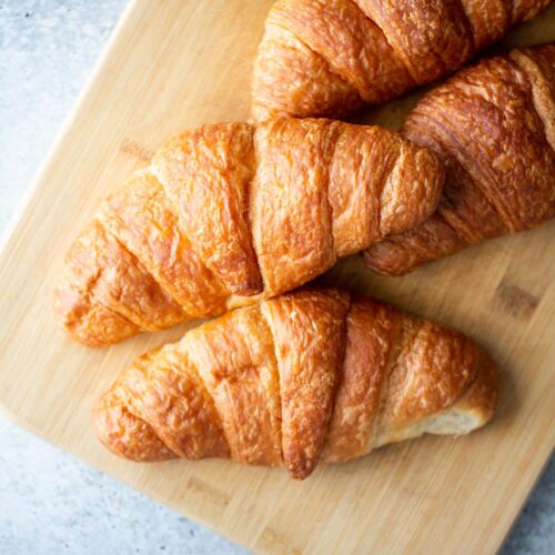 Croissants on a cutting board.