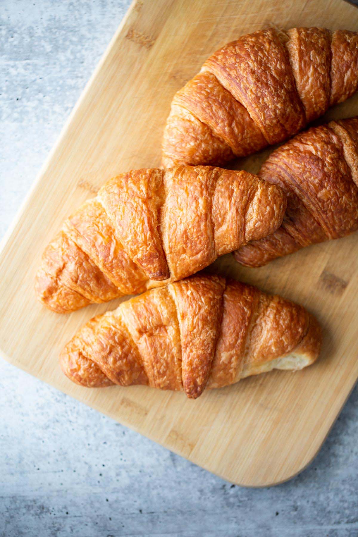 Croissants on a cutting board.