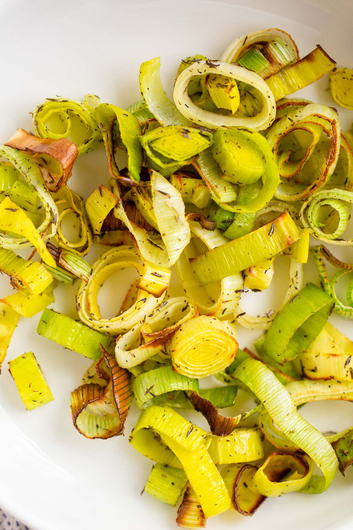 Air fried leeks in a white bowl.