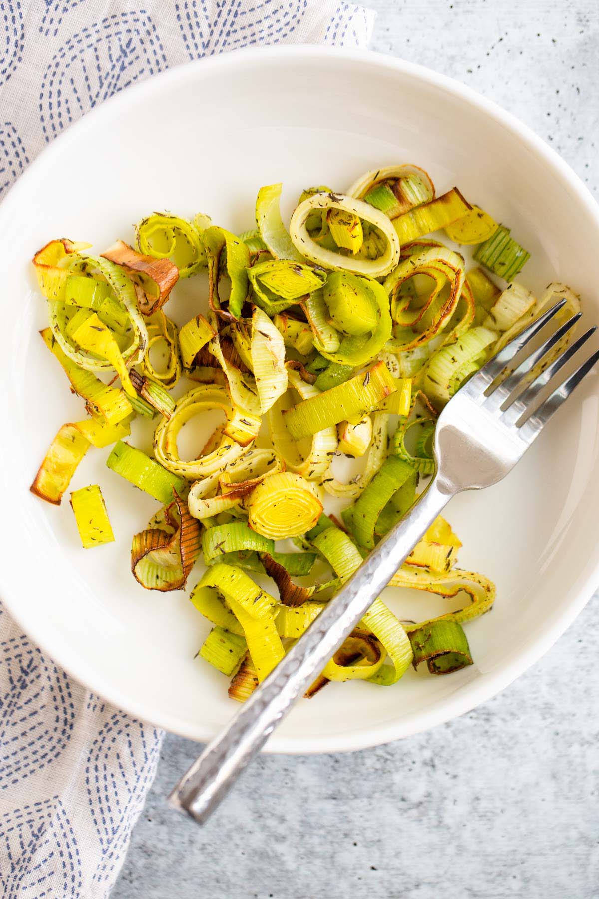 Air fried leeks in a white bowl.