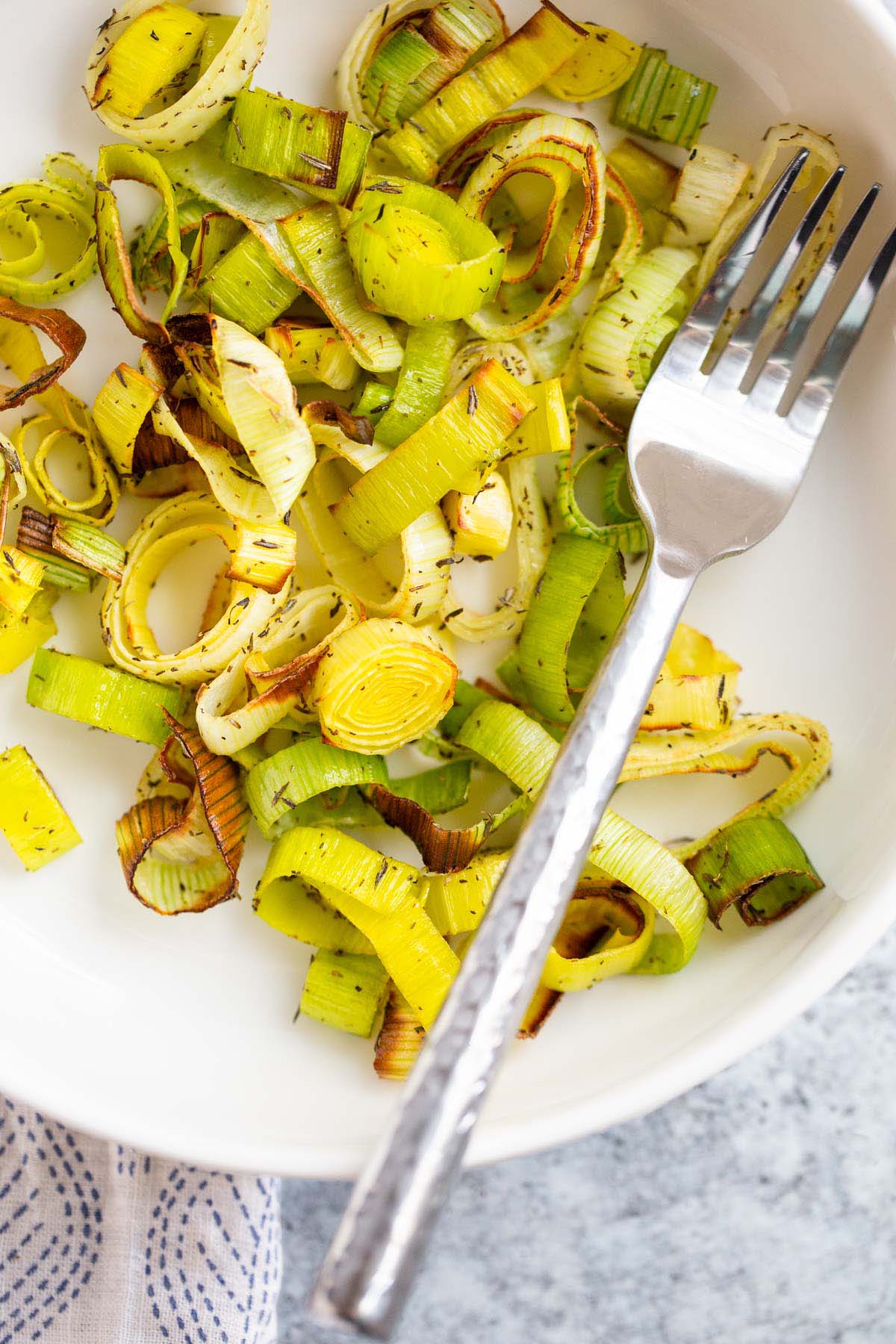 Air fried leeks in a white bowl.