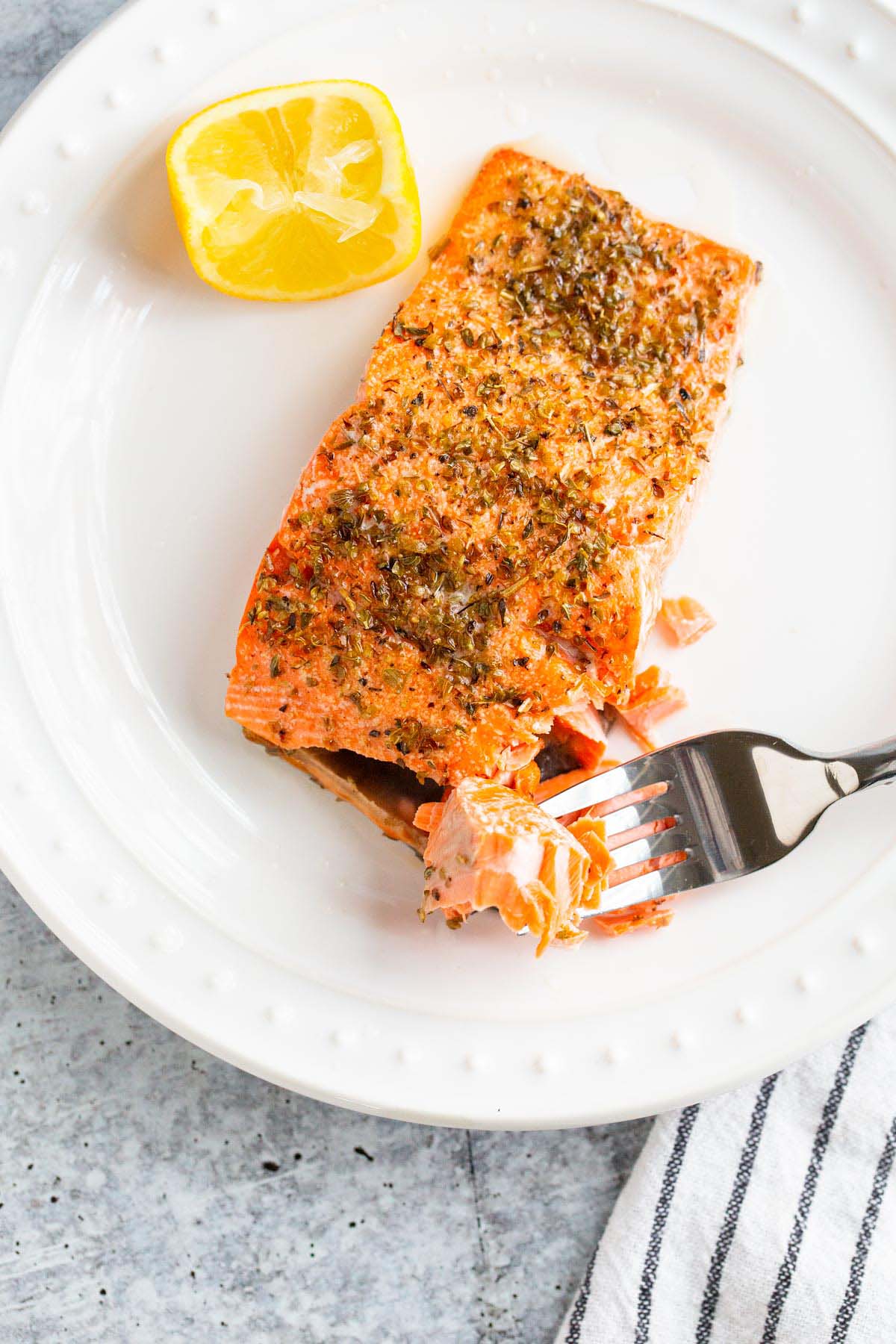 Cooked salmon flaked on a plate.