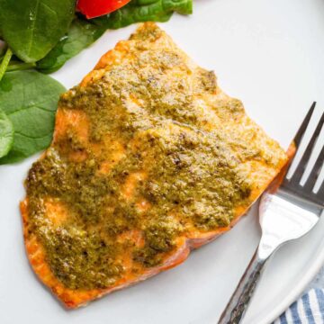 air fried pesto salmon on a white plate.