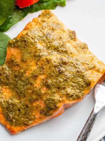 air fried pesto salmon on a white plate.