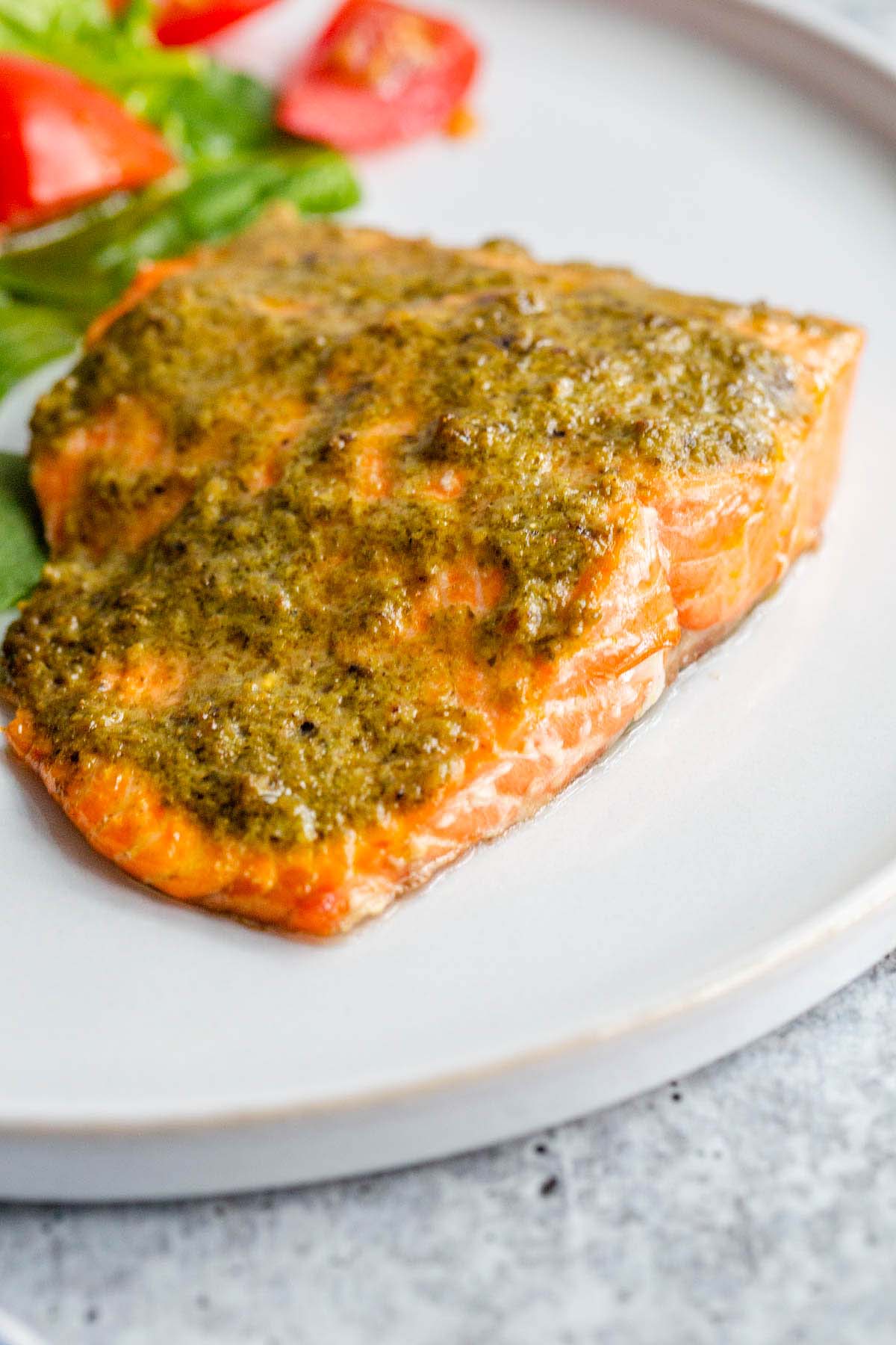 Air fryer pesto salmon on a white plate.