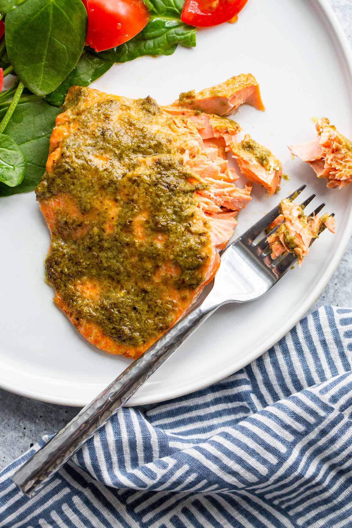 Air fryer pesto salmon flaked on a fork.