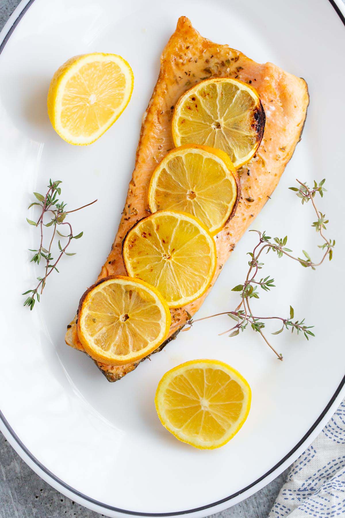 Air fryer rainbow trout topped with lemon slices.
