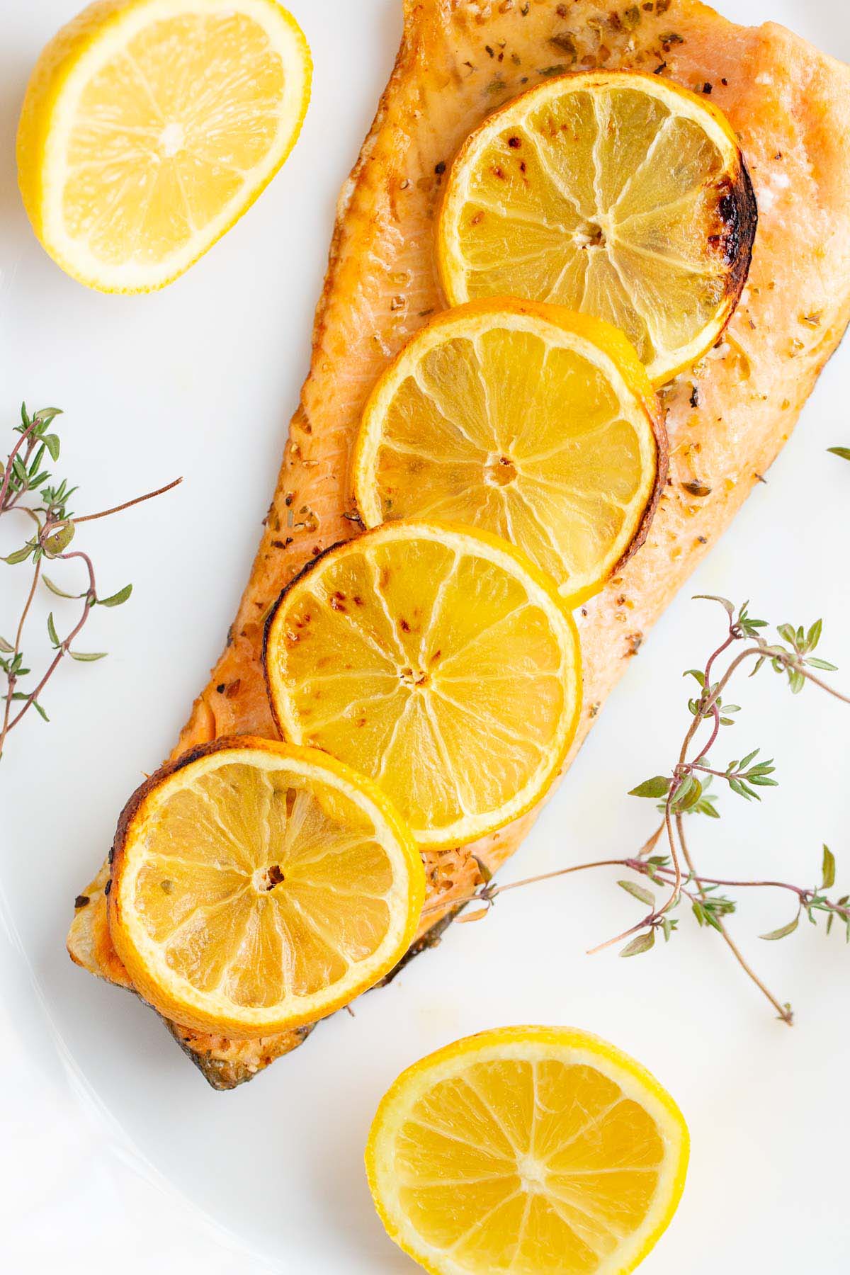 Air fryer rainbow trout topped with lemon slices.