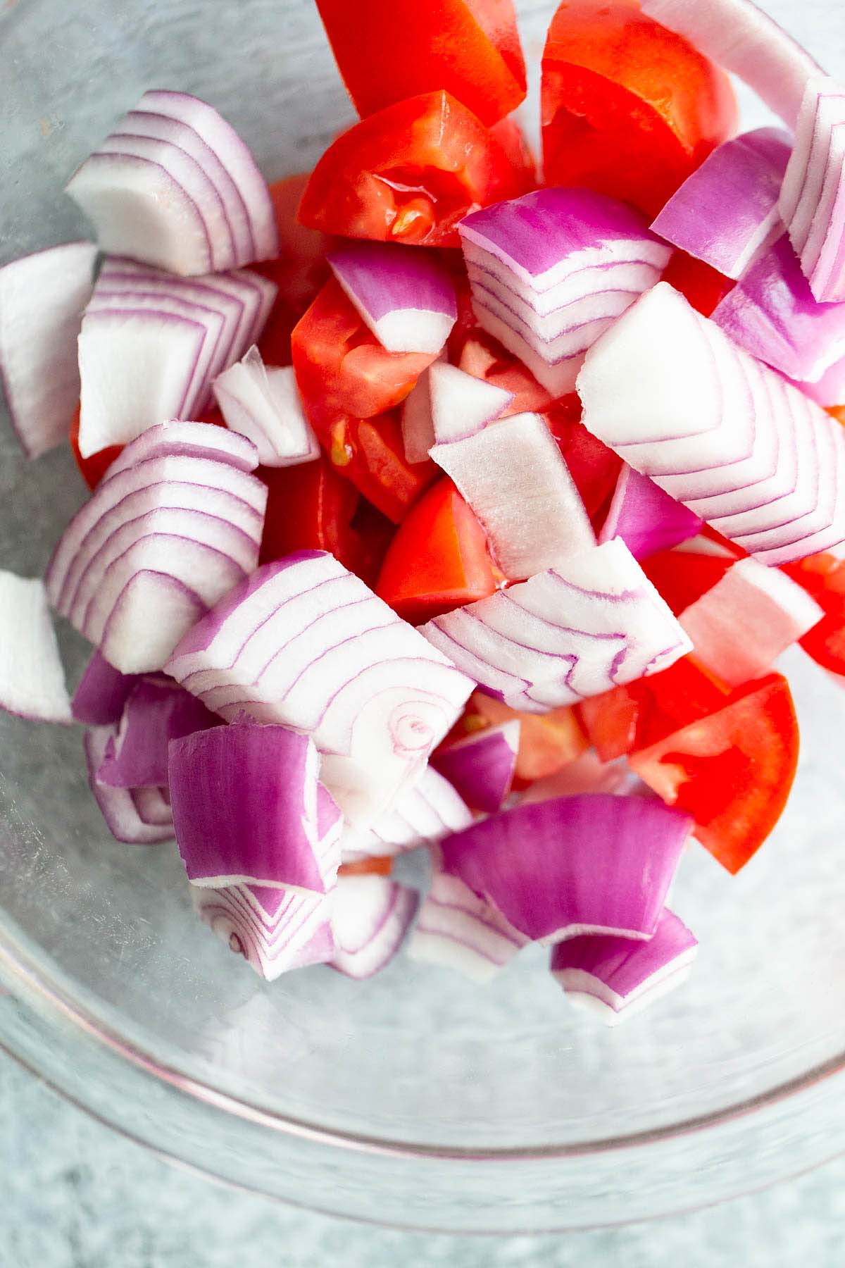 Tomatoes and onions in a bowl.